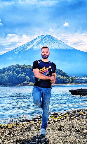 Alessandro beside a lake with Mount Fuji in the background.